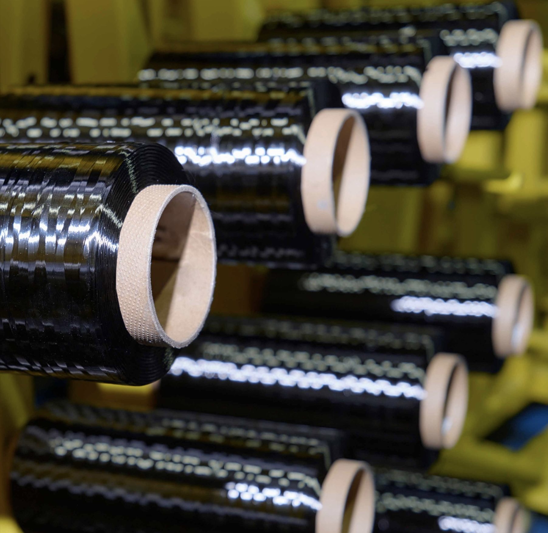 Spools of black carbon fibre tow